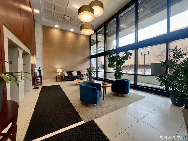 a view of living room with furniture and large windows