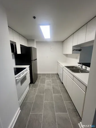 a kitchen with a cabinets and white appliances