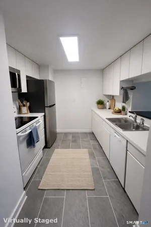 a kitchen with a sink cabinets and stainless steel appliances
