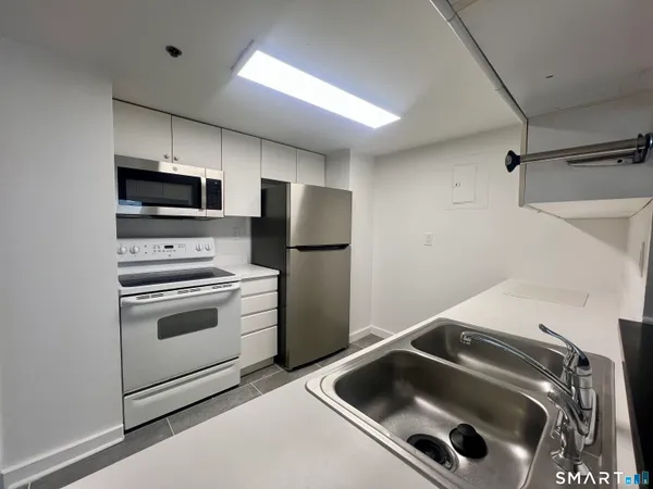 a kitchen with a stove and a refrigerator