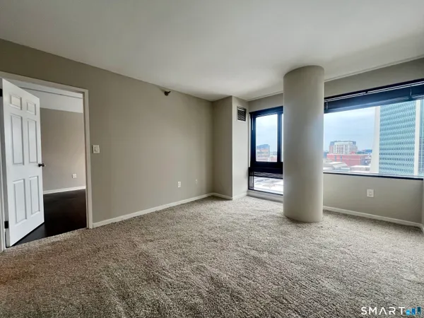 an empty room with windows and closet