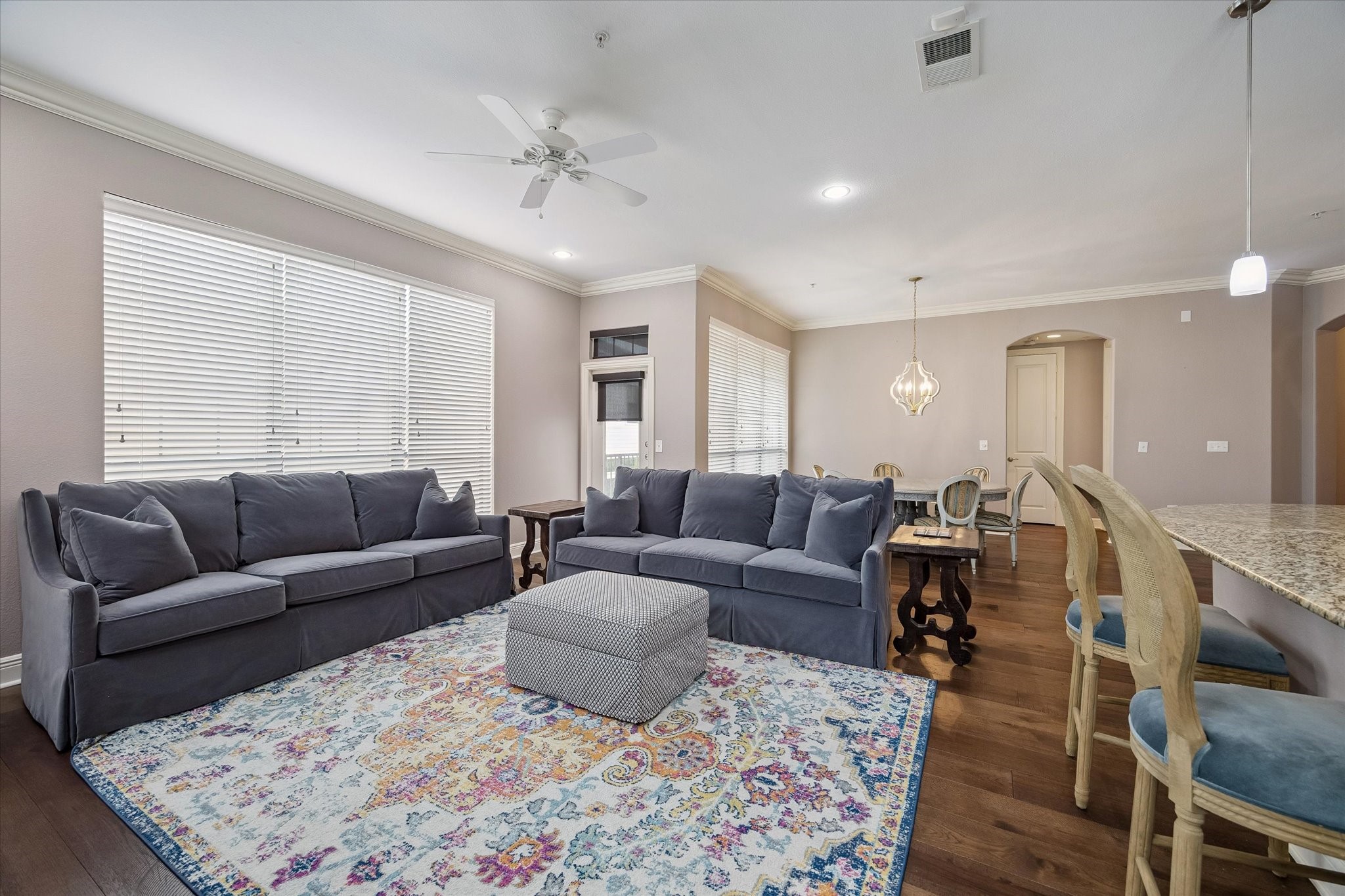 2120 Kipling Street, Unit 304 Houston, TX 77098 - Photo 13 of 24 The spacious living room offers an open and airy feel with wood flooring, crown molding, and large windows that fill the space with natural light. Seamlessly connected to the dining area and private balcony, it provides the perfect setting for entertaining or relaxing at home.