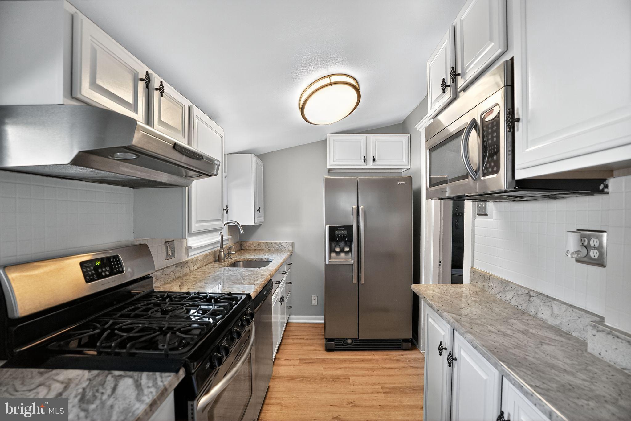 107 South Forklanding Road Maple Shade, NJ 08052 - Photo 18 of 36 a kitchen with stainless steel appliances granite countertop a stove and a sink