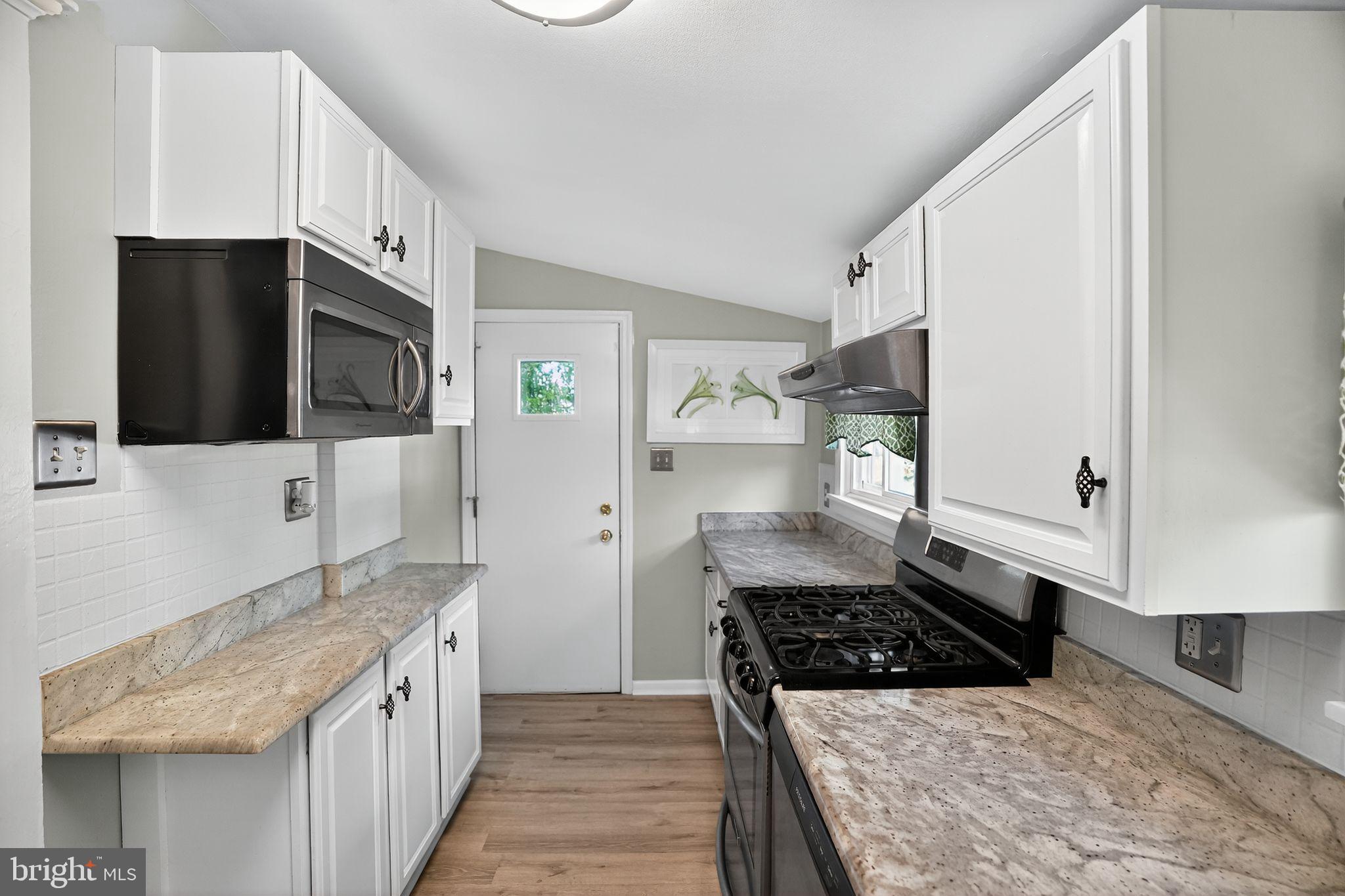 107 South Forklanding Road Maple Shade, NJ 08052 - Photo 19 of 36 a kitchen with stainless steel appliances a sink a stove a microwave a refrigerator and cabinets