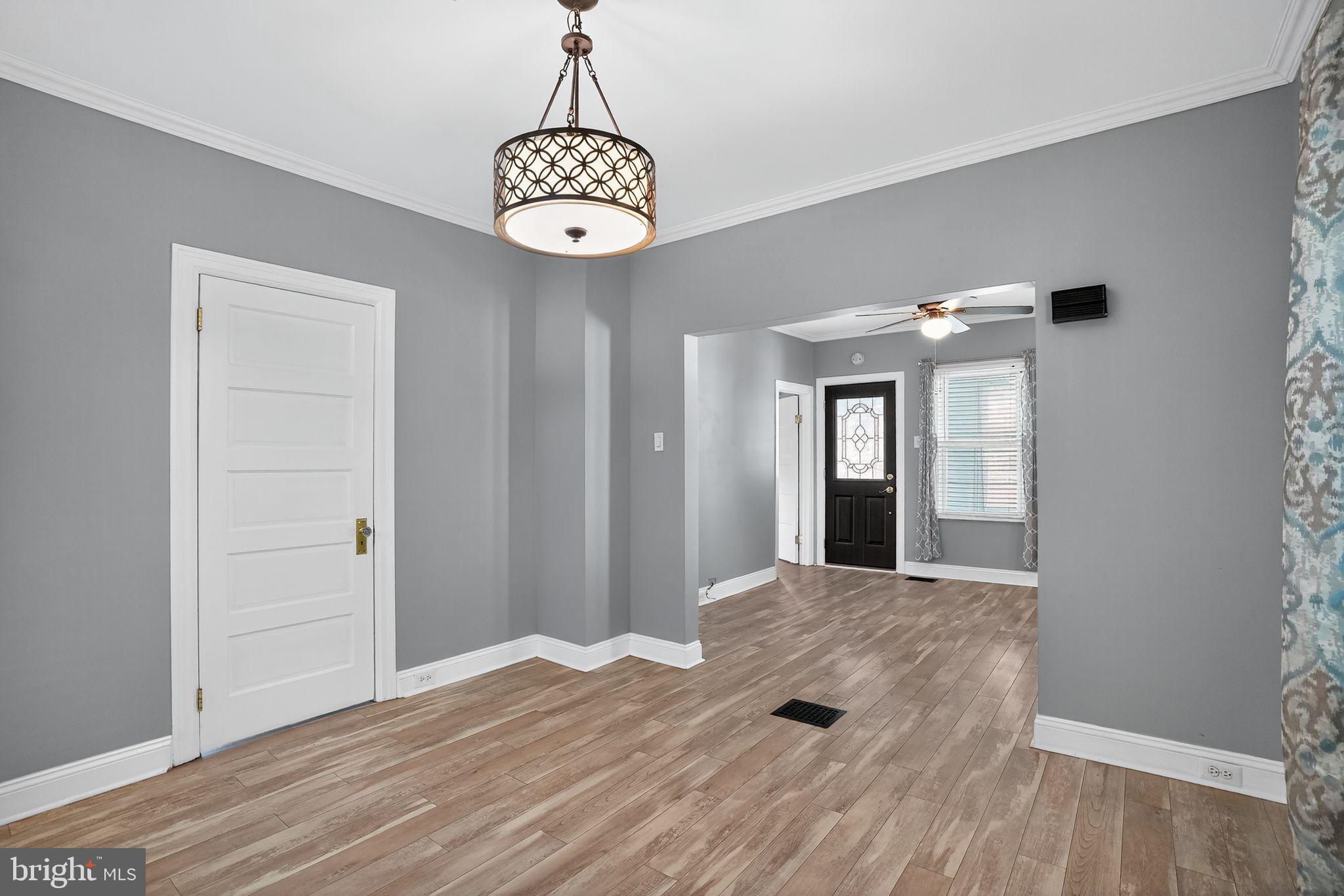 107 South Forklanding Road Maple Shade, NJ 08052 - Photo 7 of 36 a view of a hallway with wooden floor and chandelier