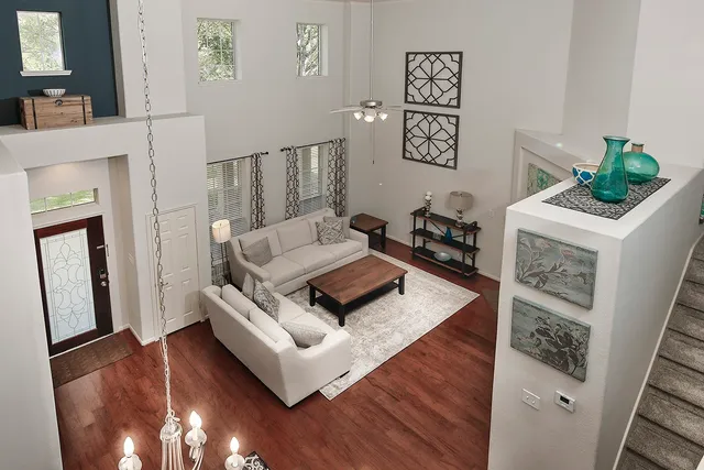 a living room with furniture and a wooden floor