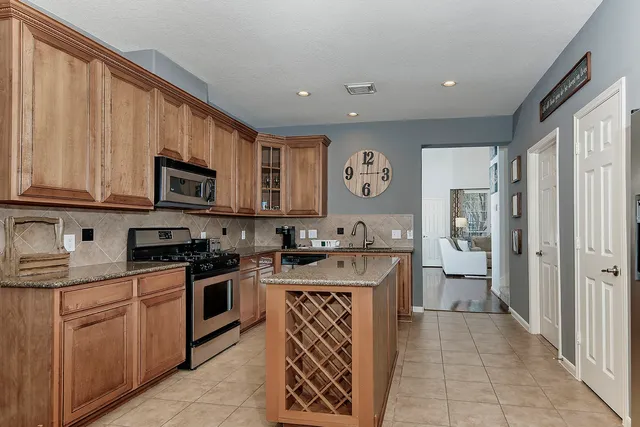 a kitchen with a stove top oven sink and cabinets