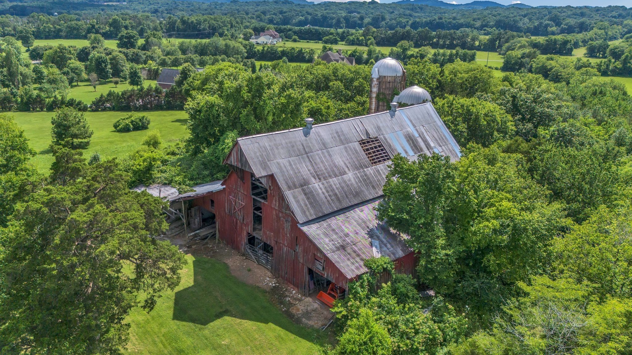 4125 Trinity Road Franklin, TN 37067 - Photo 3 of 44 an aerial view of a house with a garden and lake view
