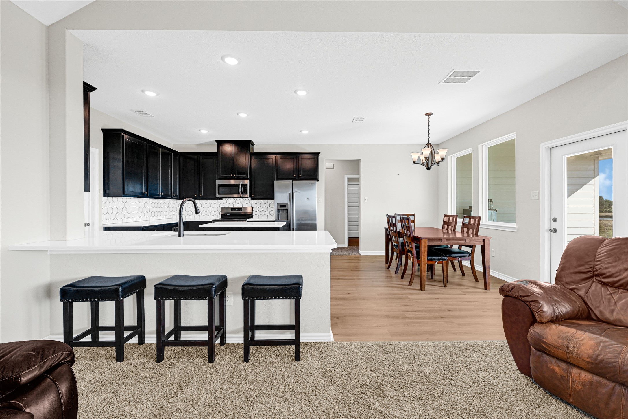2256 West Bayshore Road Anahuac, TX 77514 - Photo 16 of 34 a living room with furniture a dining table and kitchen view
