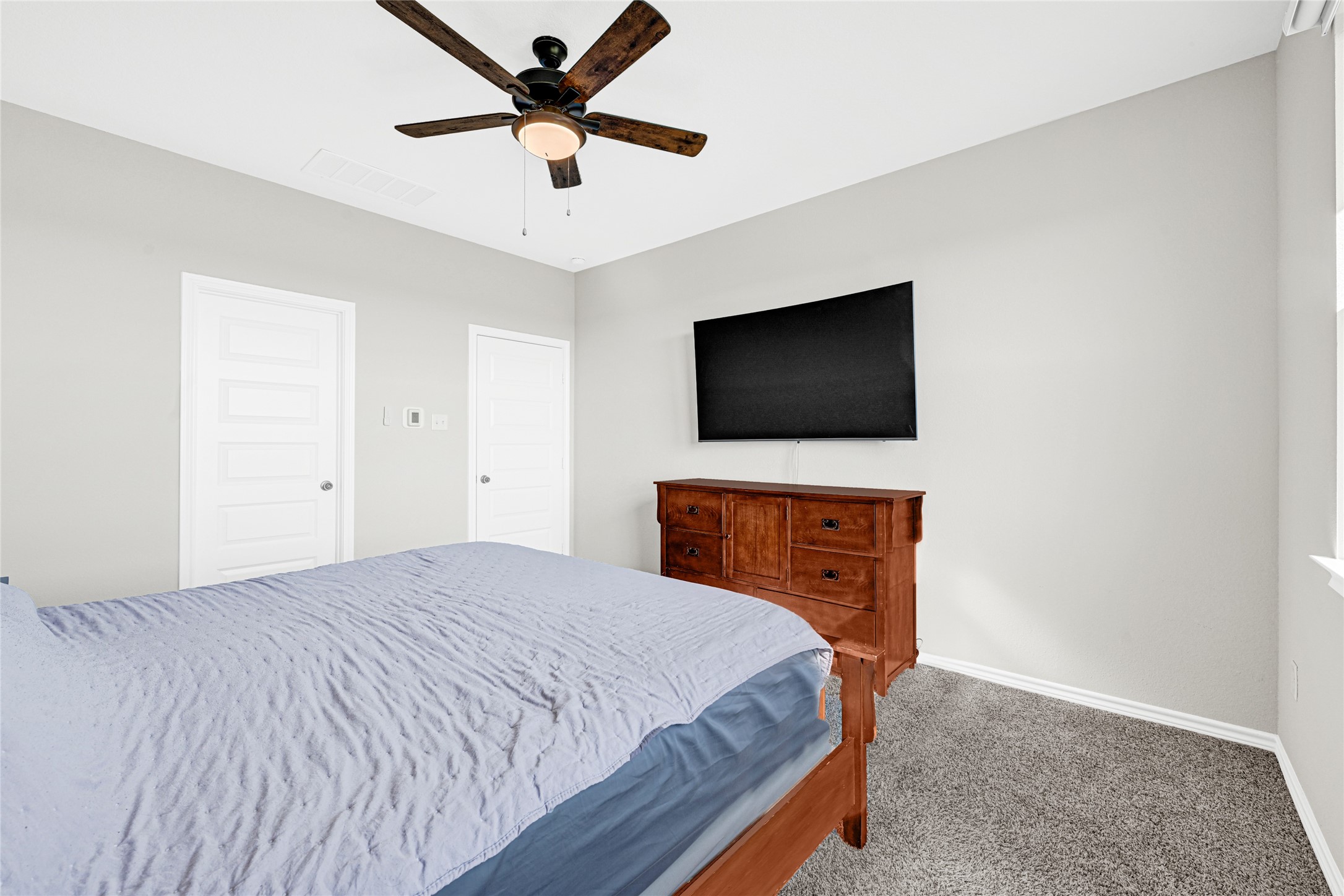 2256 West Bayshore Road Anahuac, TX 77514 - Photo 22 of 34 a bedroom with a bed and a flat screen tv