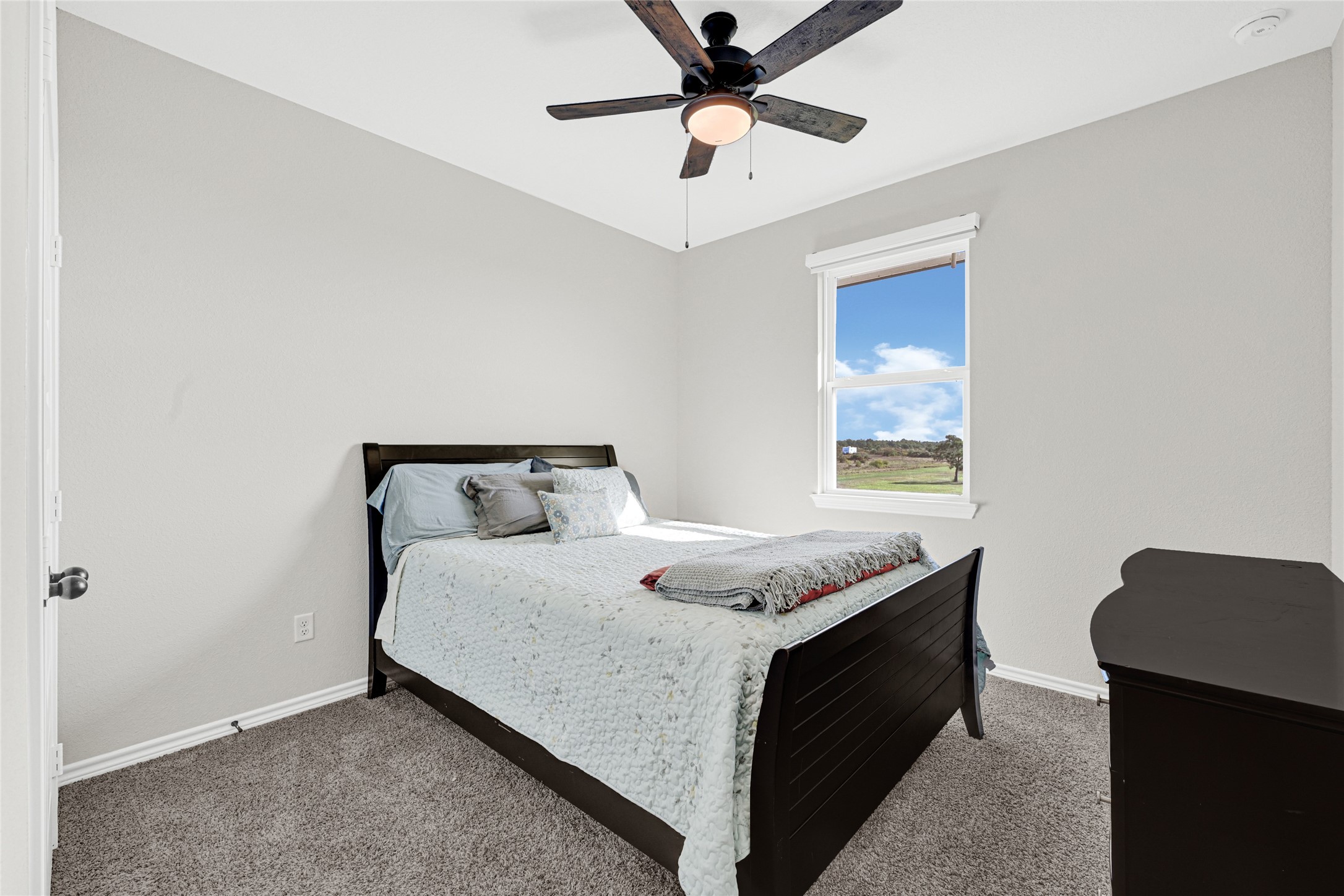 2256 West Bayshore Road Anahuac, TX 77514 - Photo 26 of 34 a bed sitting in a bedroom next to a window