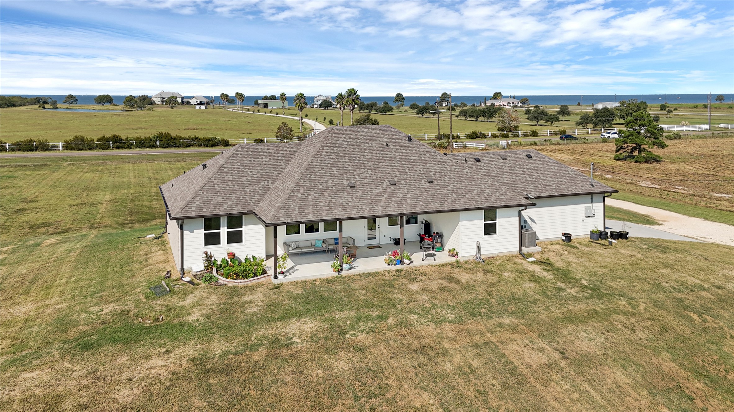 2256 West Bayshore Road Anahuac, TX 77514 - Photo 32 of 34 an aerial view of residential houses with outdoor space and ocean