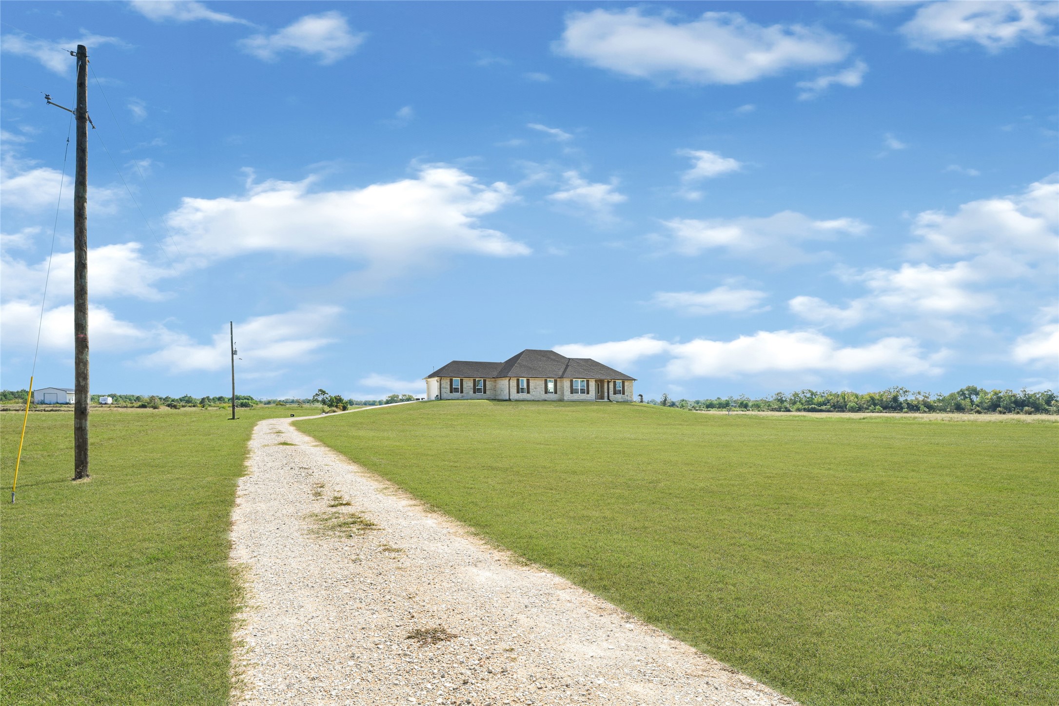 2256 West Bayshore Road Anahuac, TX 77514 - Photo 4 of 34 a view of a lake in front of house with a yard