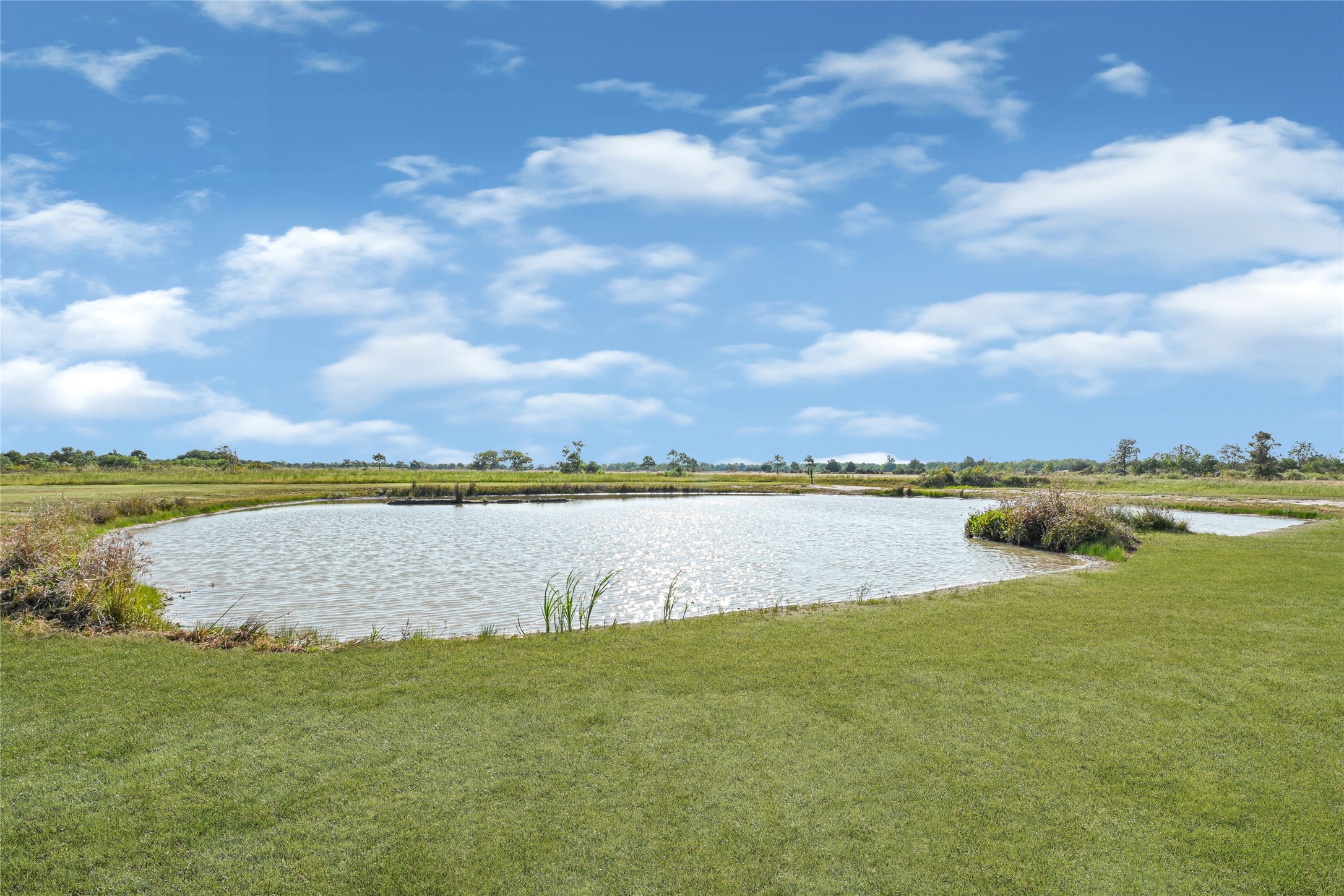 2256 West Bayshore Road Anahuac, TX 77514 - Photo 6 of 34 a view of a lake with a city