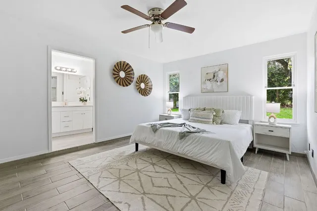 a spacious bedroom with a bed and a chandelier