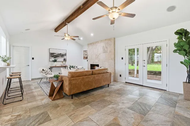 a living room with furniture and a chandelier