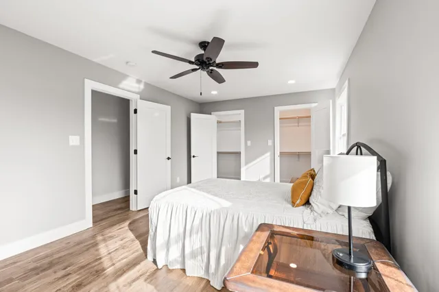 a bedroom with a bed and wooden floor