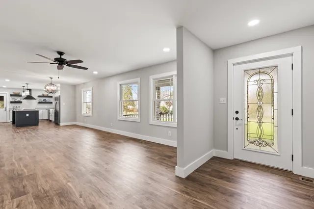 wooden floor in an empty room with a window