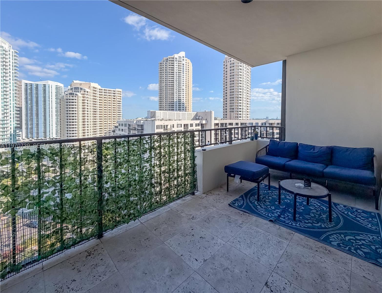 520 Brickell Key Drive, Unit A1912 Miami, FL 33131 - Photo 14 of 28 a living room with furniture and a floor to ceiling window
