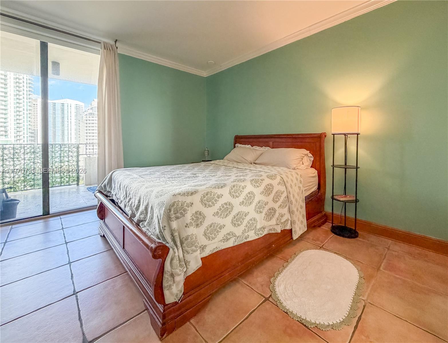 520 Brickell Key Drive, Unit A1912 Miami, FL 33131 - Photo 15 of 28 a bedroom with a bed lamp and window