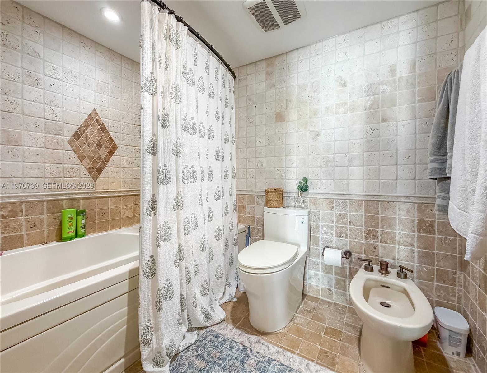 520 Brickell Key Drive, Unit A1912 Miami, FL 33131 - Photo 19 of 28 a bathroom with a toilet and a shower curtain