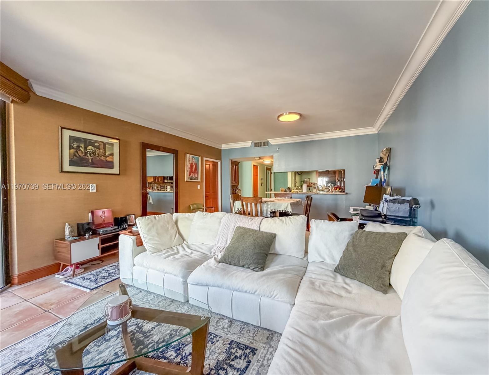 520 Brickell Key Drive, Unit A1912 Miami, FL 33131 - Photo 2 of 28 a living room with furniture and paintings on the wall