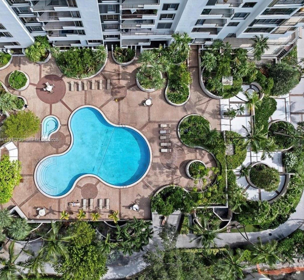 520 Brickell Key Drive, Unit A1912 Miami, FL 33131 - Photo 23 of 28 an aerial view of a house with a swimming pool a yard and outdoor seating