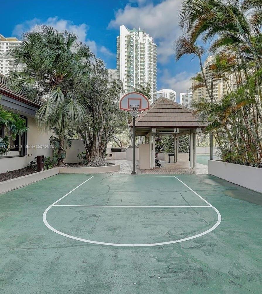 520 Brickell Key Drive, Unit A1912 Miami, FL 33131 - Photo 26 of 28 a view of a patio with table and chairs and a barbeque with potted plants