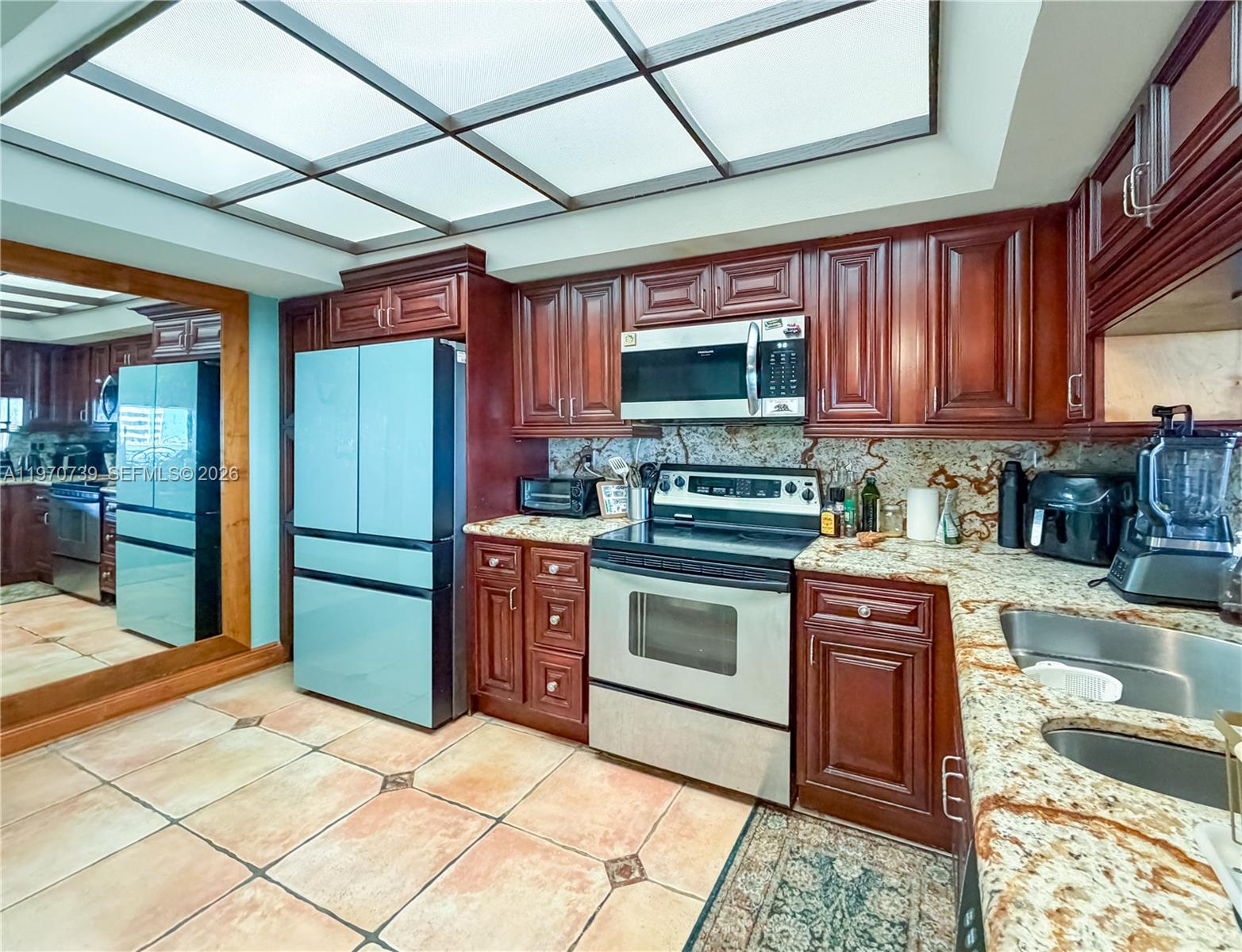 520 Brickell Key Drive, Unit A1912 Miami, FL 33131 - Photo 9 of 28 a kitchen with stainless steel appliances granite countertop a stove a sink and a refrigerator