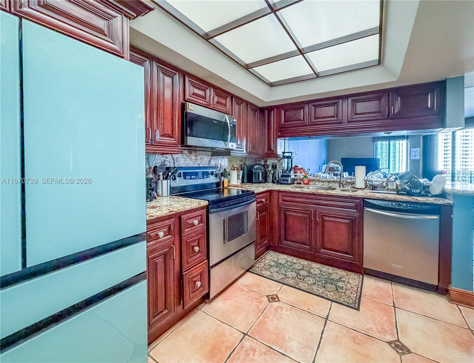 520 Brickell Key Drive, Unit A1912 Miami, FL 33131 - Photo 10 of 28 a kitchen with a stove a sink and a microwave