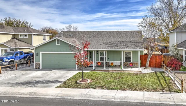a front view of the house with outdoor seating
