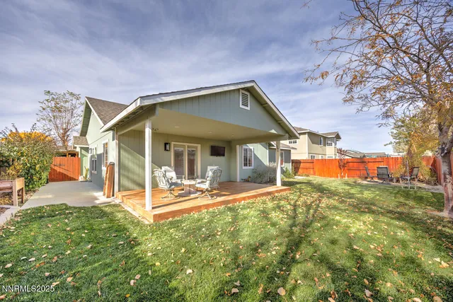 a view of a house with a yard patio and fire pit