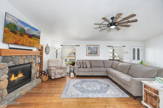 a living room with furniture a fireplace with wooden floor