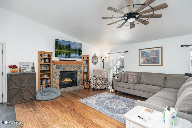 a living room with furniture a fireplace and a flat screen tv