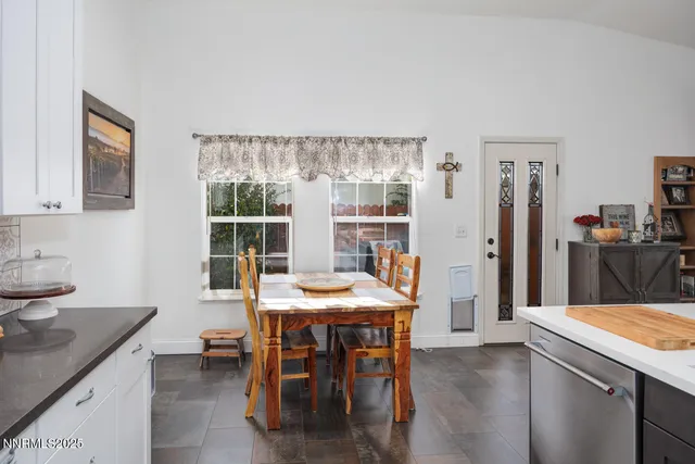 a kitchen with a table and chairs in it