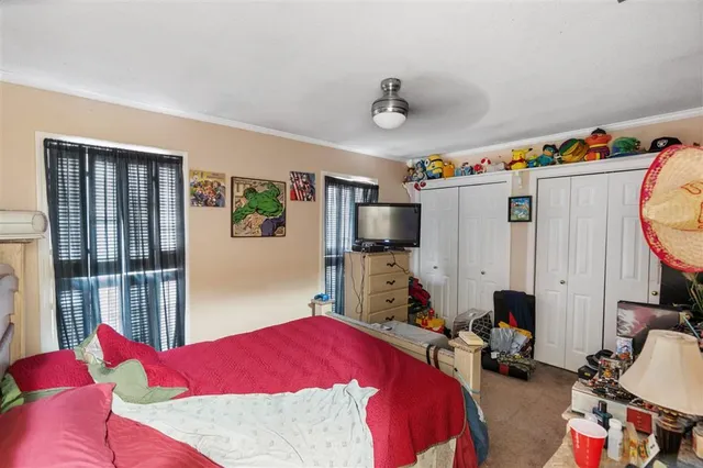 a bedroom with bed and a window