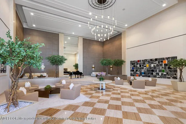 a living room with patio furniture and a chandelier