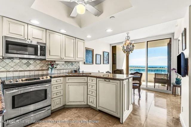 a kitchen with stainless steel appliances a stove sink microwave and cabinets