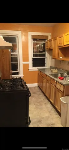 a kitchen with stainless steel appliances kitchen island granite countertop a stove top oven