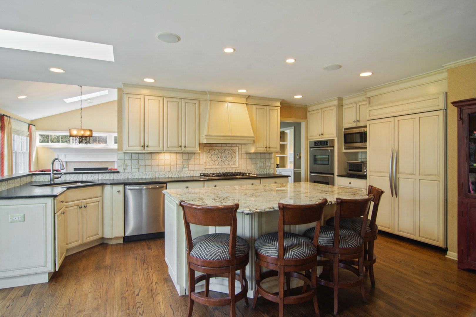 2540 Shannon Road Northbrook, IL 60062 - Photo 7 of 32 a kitchen with kitchen island granite countertop wooden cabinets and counter space