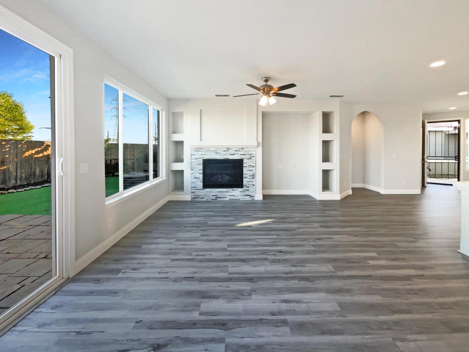 4087 Preserve Way Rancho Cordova, CA 95742 - Photo 12 of 24 an empty room with wooden floor fireplace and windows