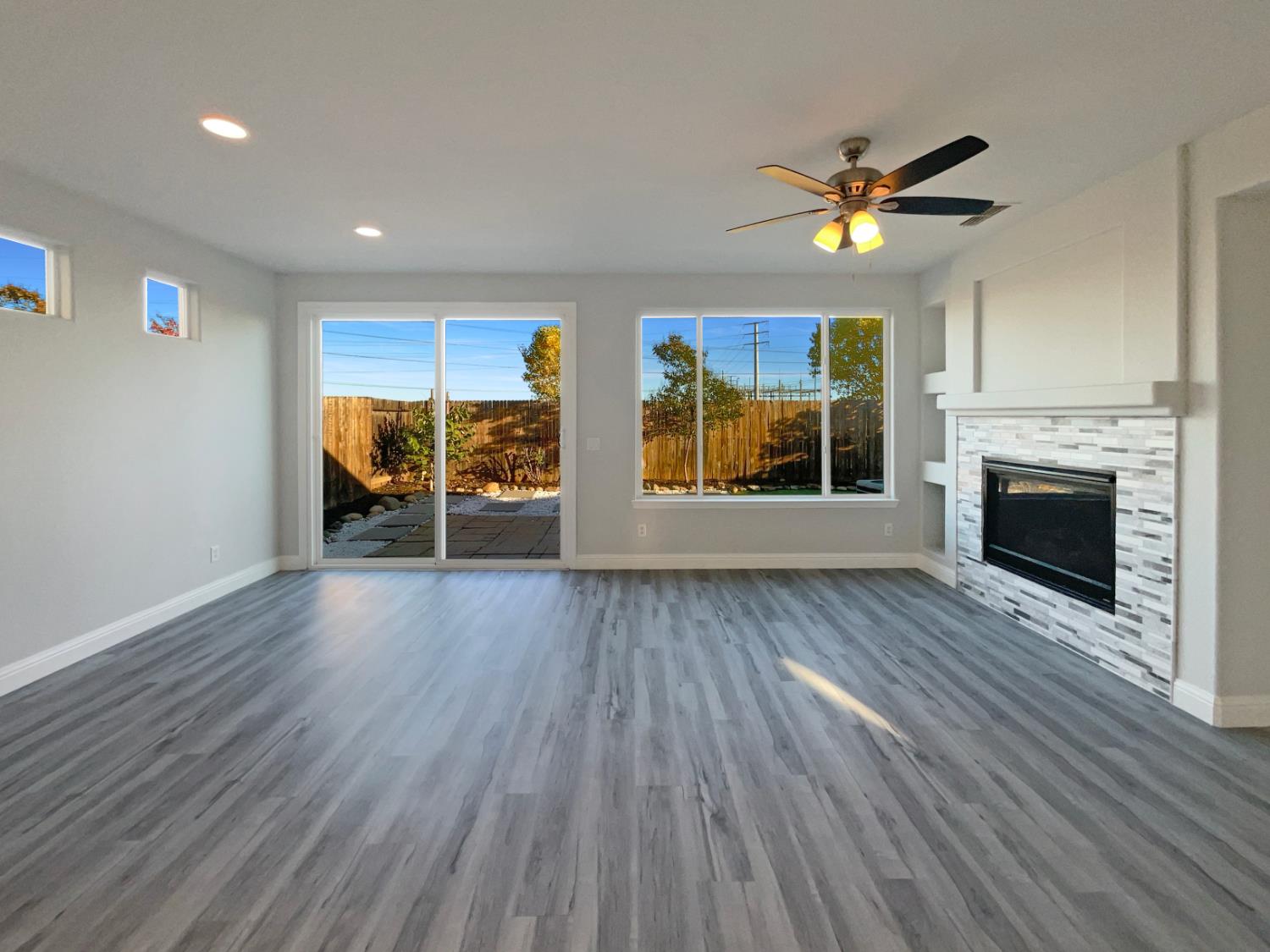 4087 Preserve Way Rancho Cordova, CA 95742 - Photo 3 of 24 an empty room with wooden floor fireplace and windows