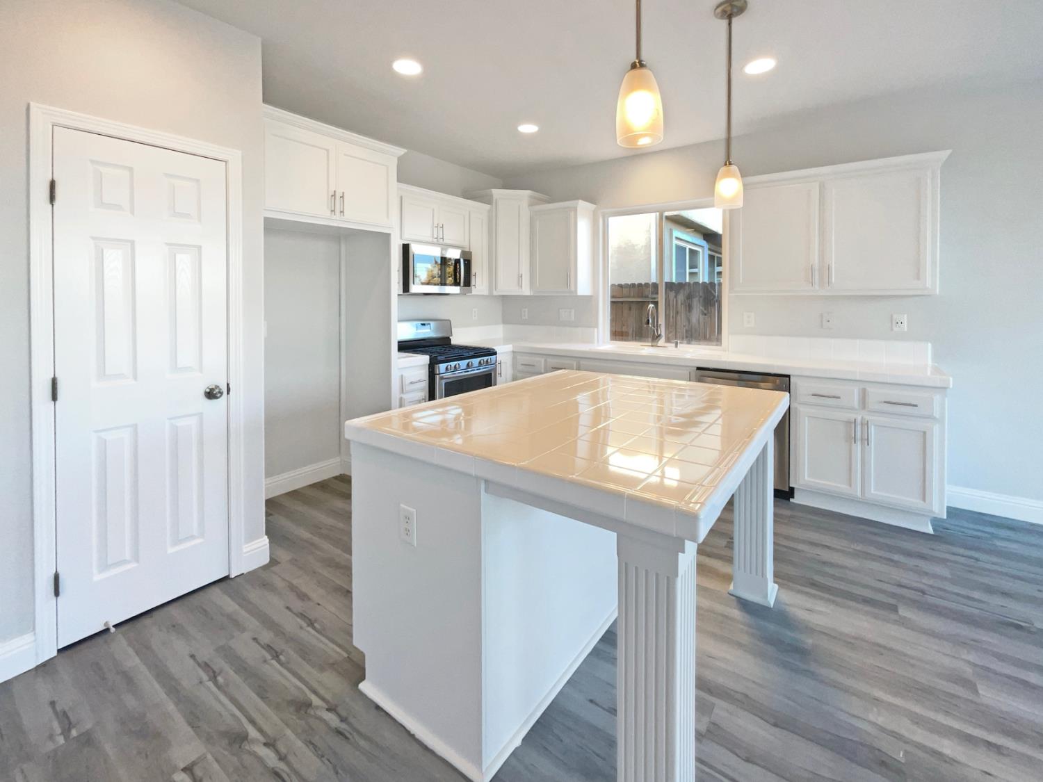 4087 Preserve Way Rancho Cordova, CA 95742 - Photo 6 of 24 a view of a kitchen with wooden floor and window