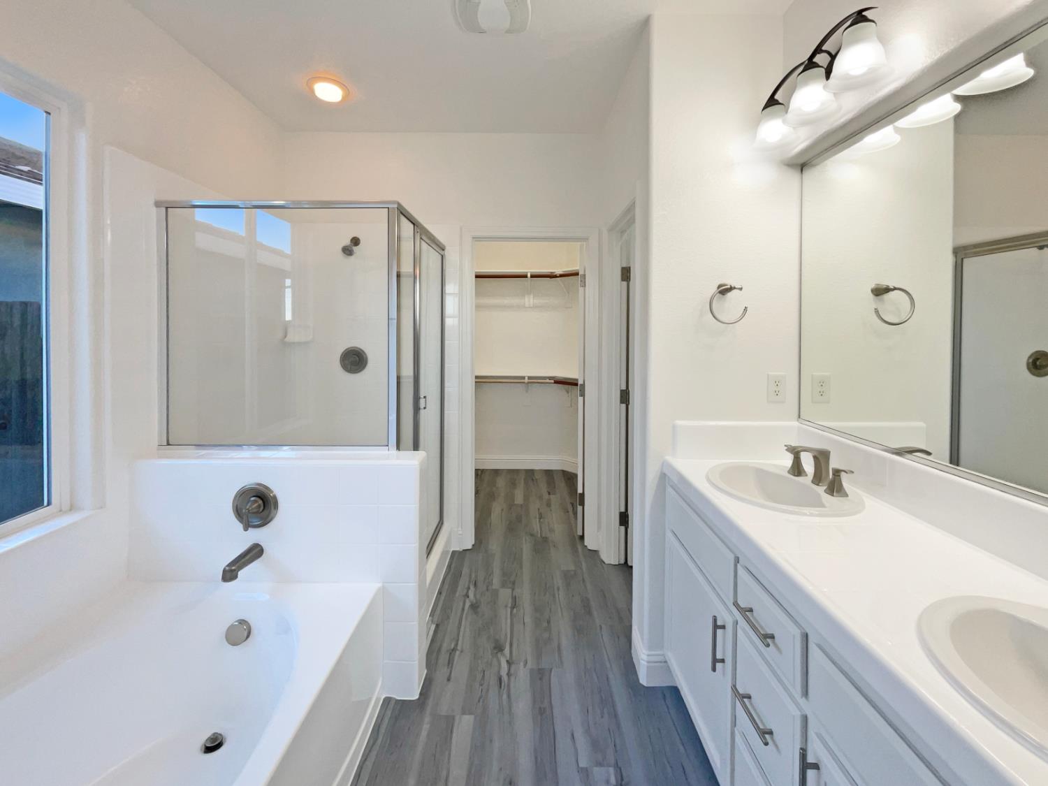 4087 Preserve Way Rancho Cordova, CA 95742 - Photo 7 of 24 a bathroom with a tub a sink and a large mirror