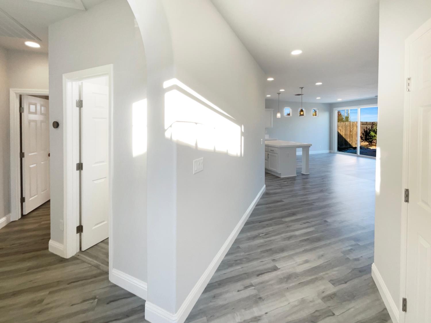4087 Preserve Way Rancho Cordova, CA 95742 - Photo 10 of 24 a view of a hallway with wooden floor and a bathroom