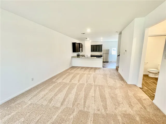a view of a living room with furniture and a flat screen tv