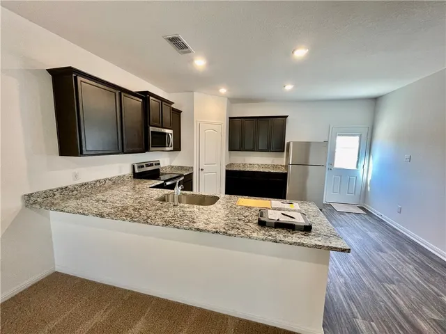 a living room with fireplace furniture and a flat screen tv