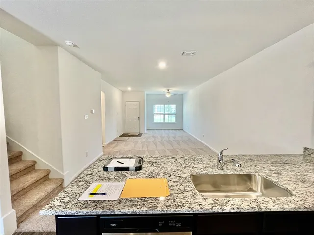 a view of a living room and kitchen