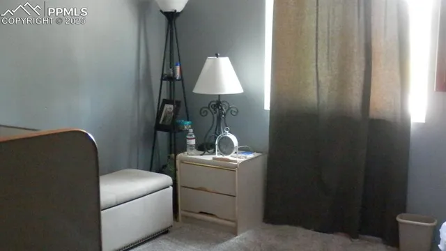 a bedroom with a bed and a lamp
