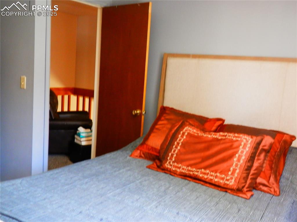 4450 Chaparral Road Colorado Springs, CO 80917 - Photo 16 of 29 a blue bed sitting in a bedroom next to a window